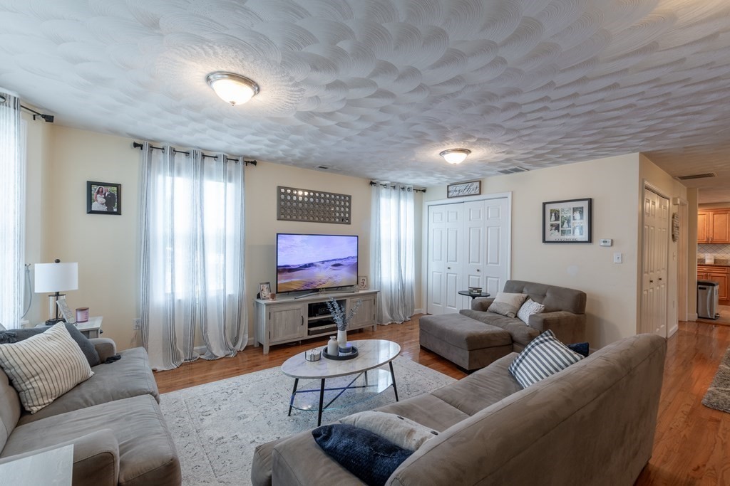 97 Bay State Road Methuen, MA 01844 - Photo 4 of 26 a living room with furniture and a flat screen tv