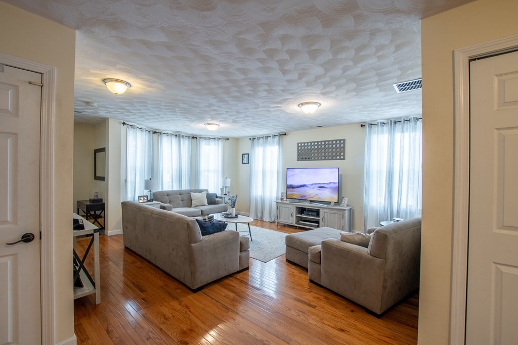 97 Bay State Road Methuen, MA 01844 - Photo 6 of 26 a living room with furniture and a fireplace
