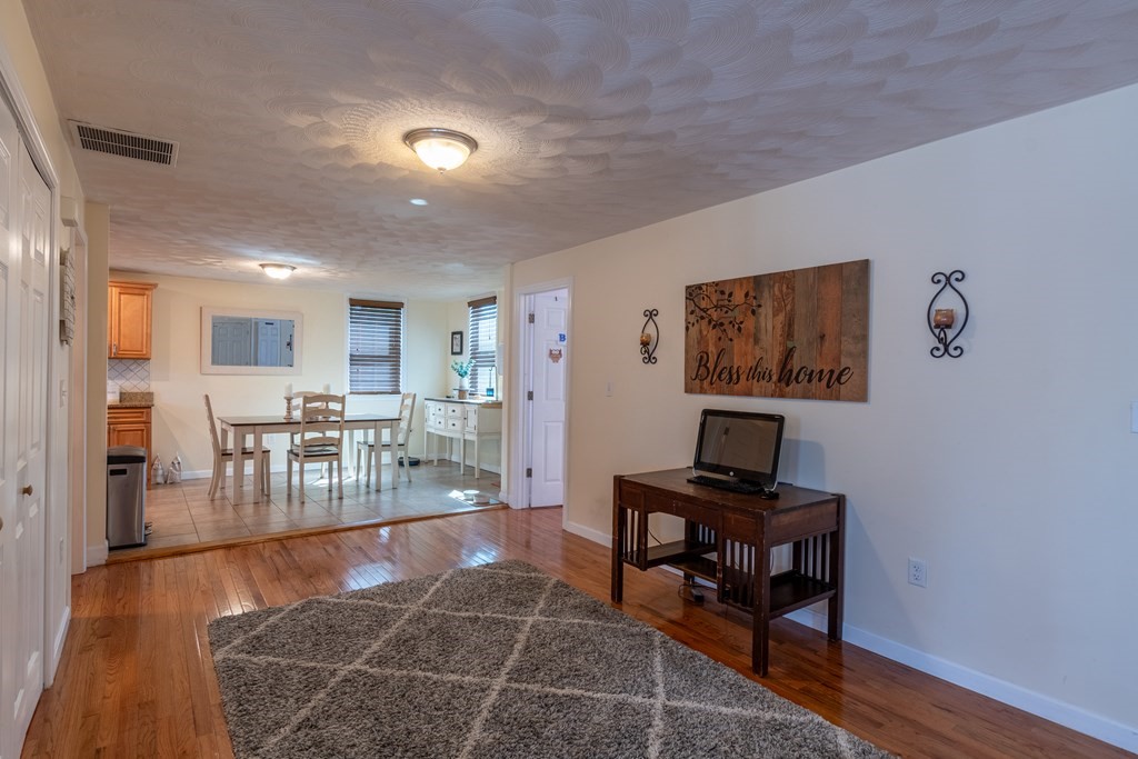 97 Bay State Road Methuen, MA 01844 - Photo 8 of 26 a living room with furniture and a wooden floor