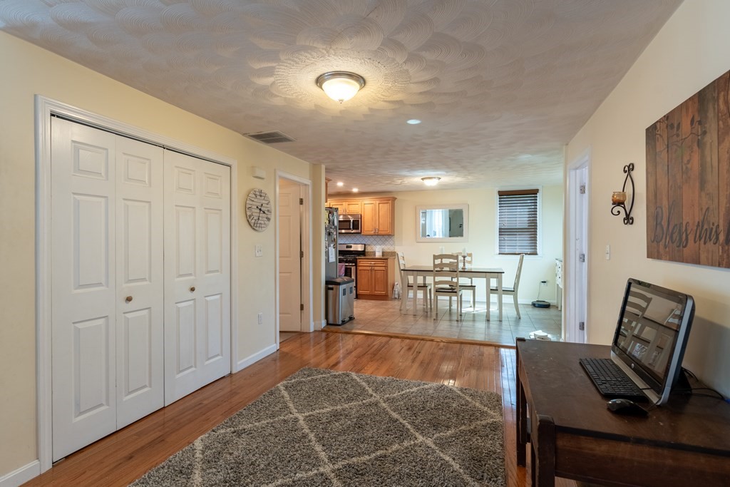 97 Bay State Road Methuen, MA 01844 - Photo 9 of 26 a living room with furniture a dining table and chairs