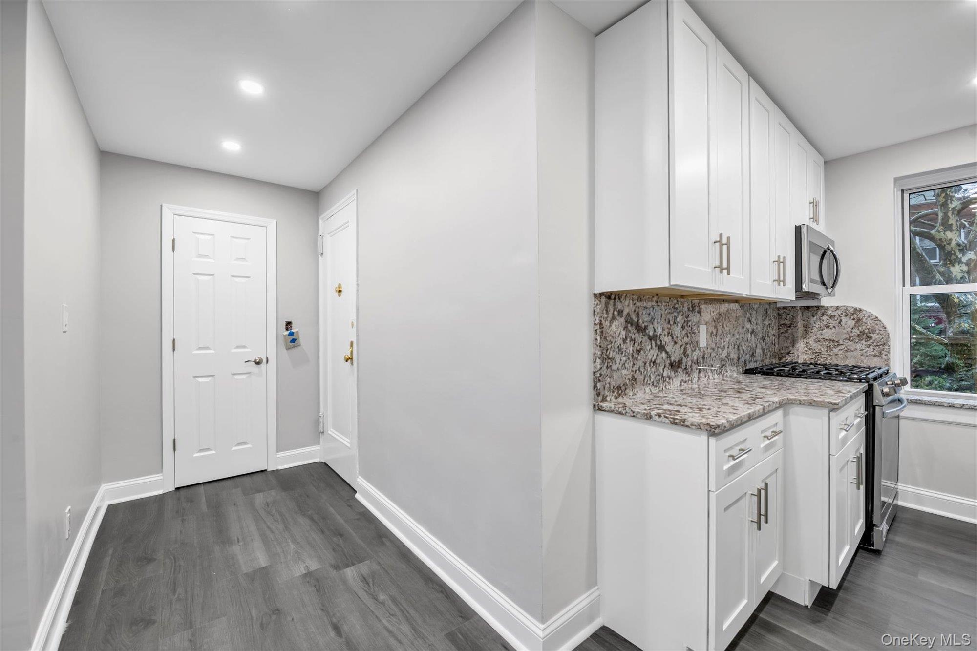 79-06 Main Street, Unit 2J Queens, NY 11367 - Photo 5 of 12 a bathroom with a granite countertop sink and a granite counter tops