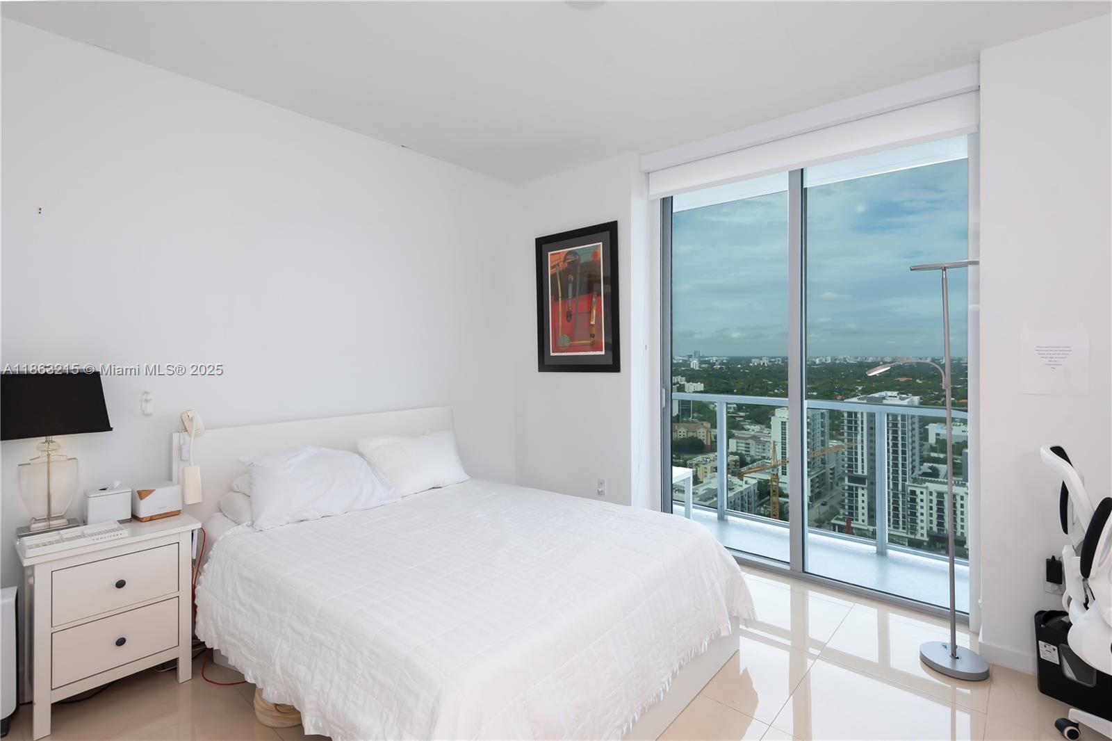 1111 Southwest 1st Avenue, Unit 3125N Miami, FL 33130 - Photo 11 of 49 a bedroom with a large bed and a flat tv screen next to a window
