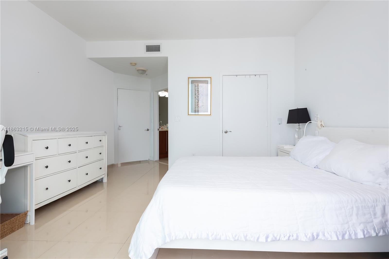 1111 Southwest 1st Avenue, Unit 3125N Miami, FL 33130 - Photo 12 of 49 a bedroom with a bed and a cabinets