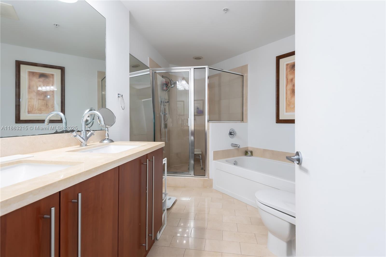 1111 Southwest 1st Avenue, Unit 3125N Miami, FL 33130 - Photo 16 of 49 a bathroom with a sink double vanity granite tub shower and a mirror