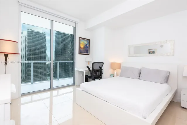 a view of a balcony with potted plants and palm trees