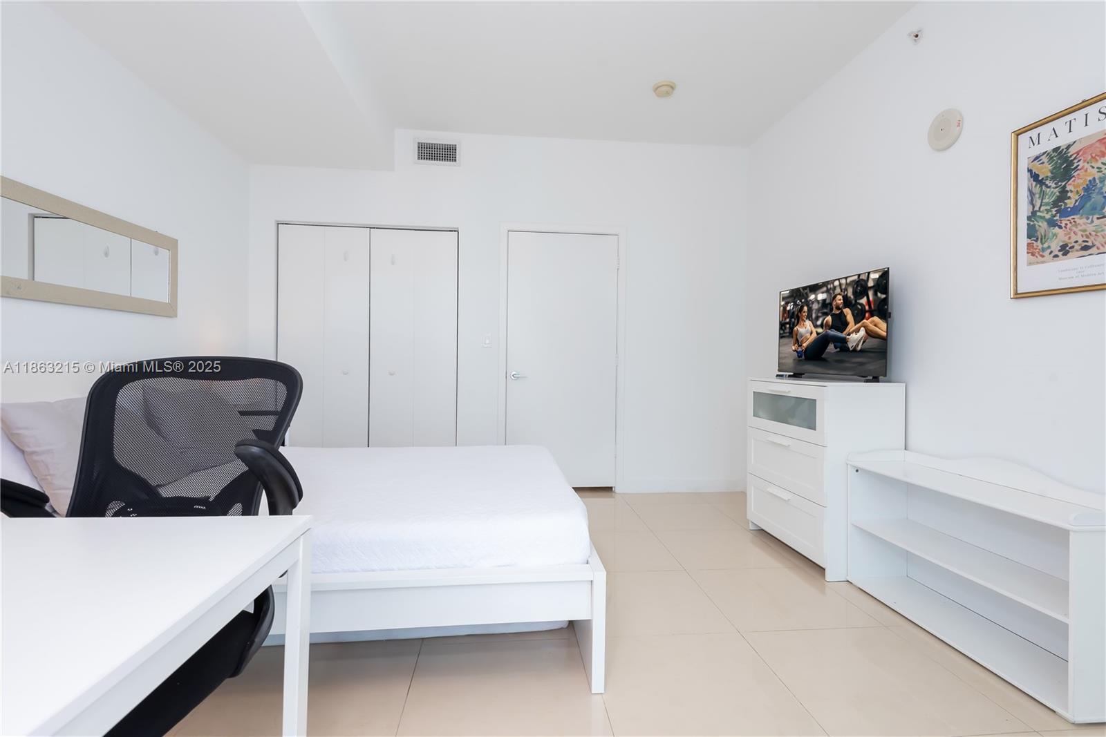 1111 Southwest 1st Avenue, Unit 3125N Miami, FL 33130 - Photo 24 of 49 a bedroom with a bed and cabinets