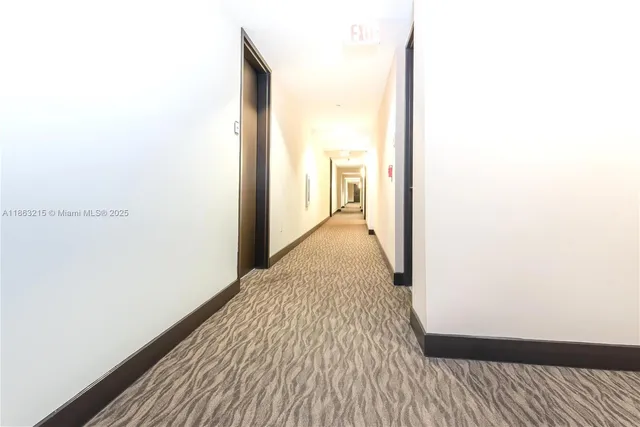 a kitchen with stainless steel appliances kitchen island granite countertop a refrigerator a stove top oven a sink and a large window