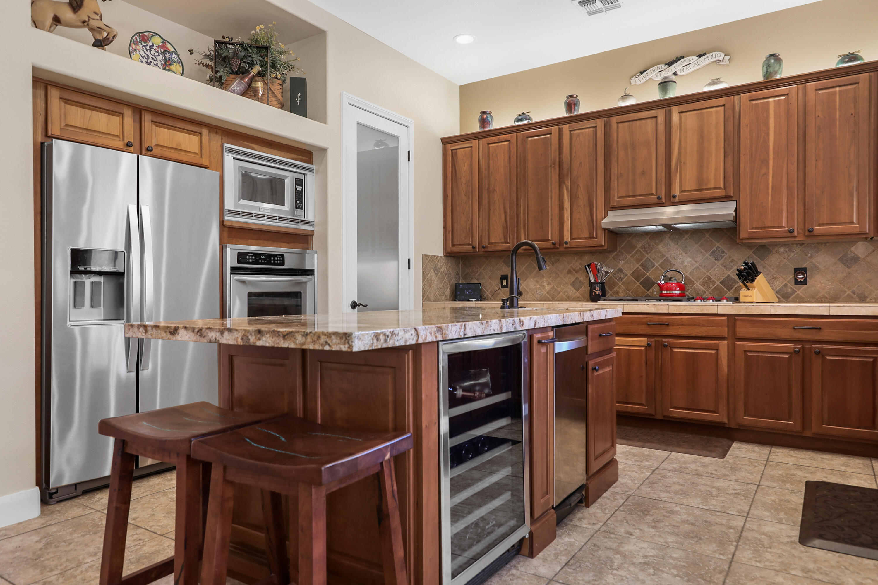54855 Avenida Madero La Quinta, CA 92253 - Photo 14 of 48 a kitchen with stainless steel appliances a stove a sink and a refrigerator