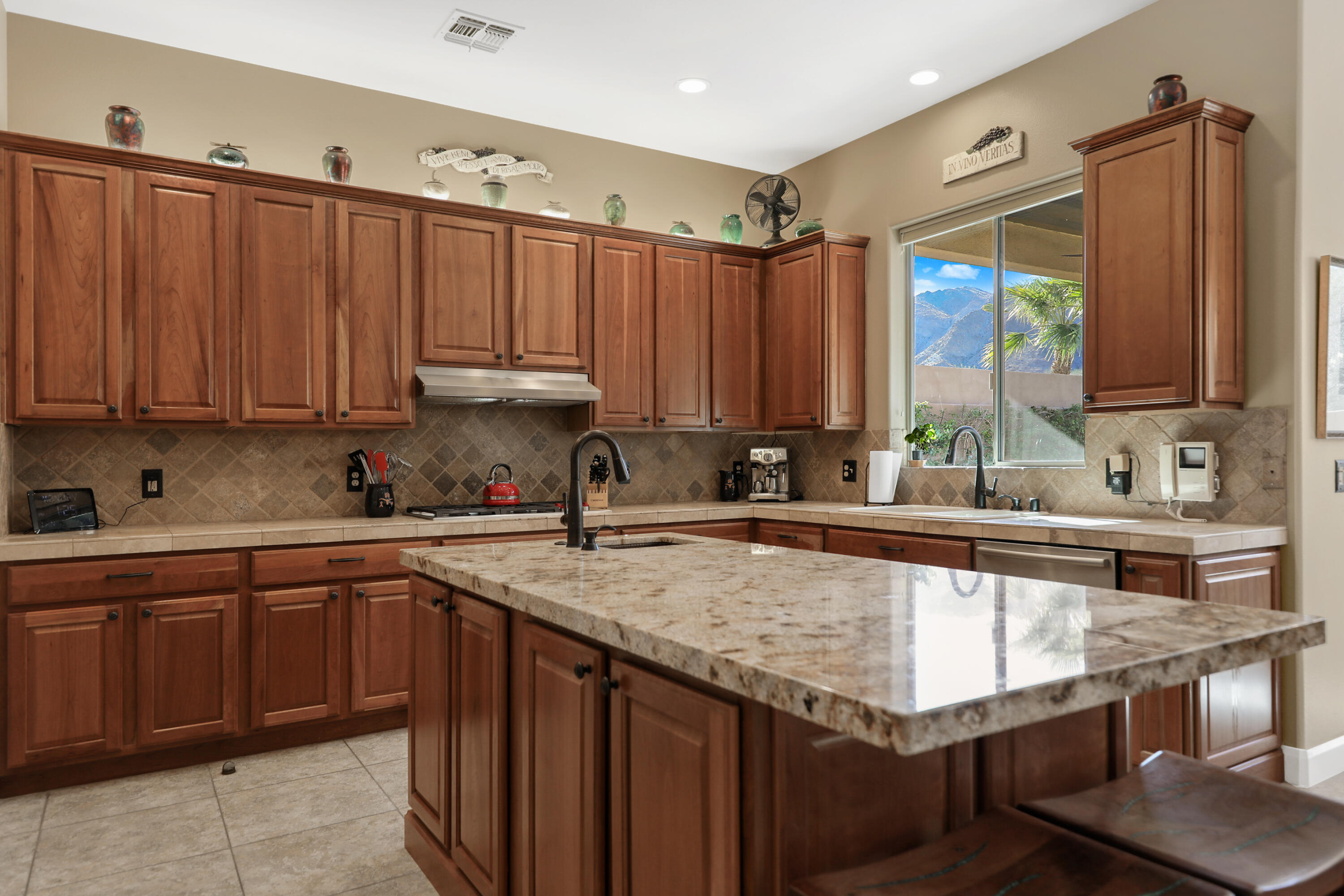 54855 Avenida Madero La Quinta, CA 92253 - Photo 15 of 48 a kitchen with a sink stove and cabinets