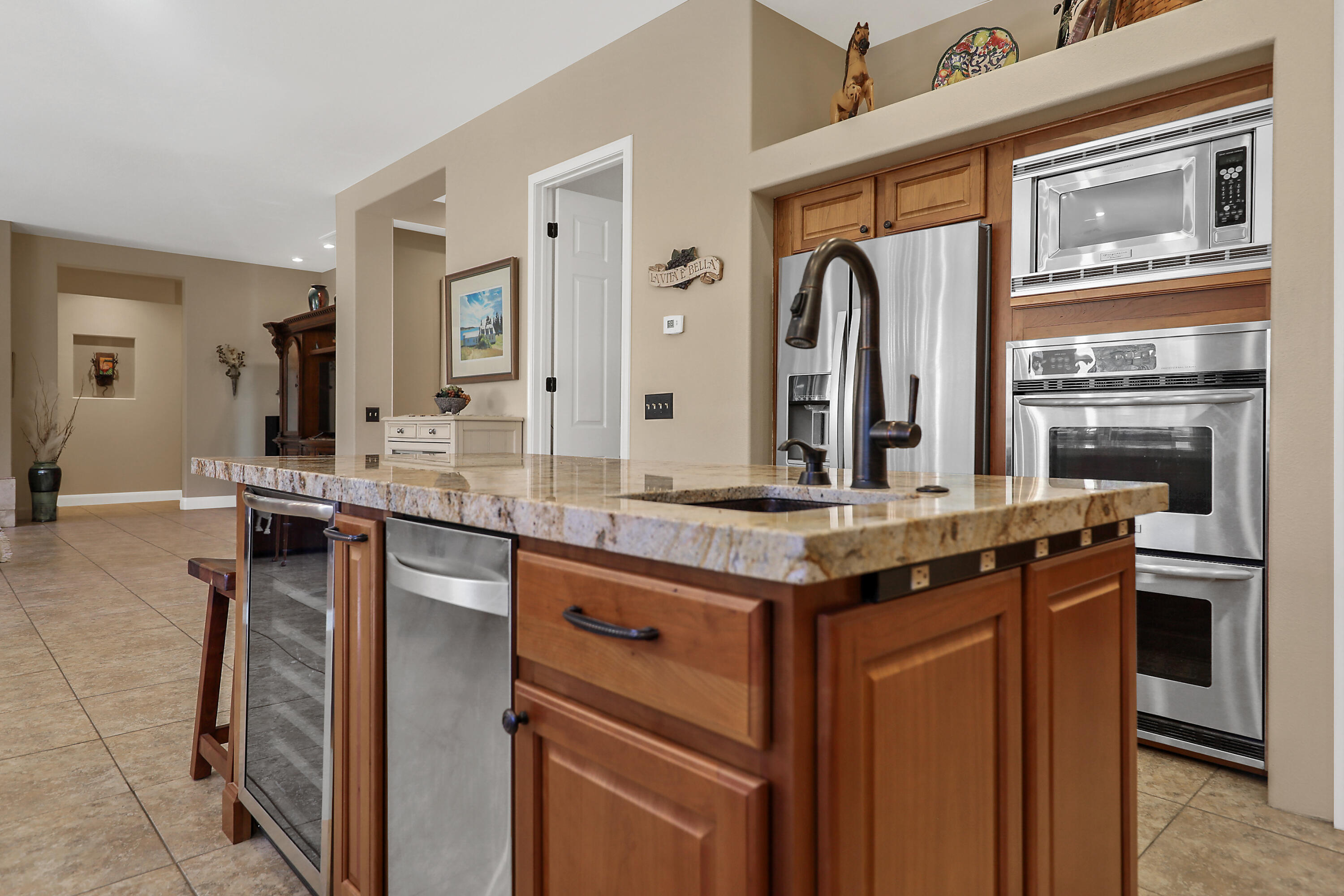54855 Avenida Madero La Quinta, CA 92253 - Photo 17 of 48 a kitchen with stainless steel appliances granite countertop a stove and a sink