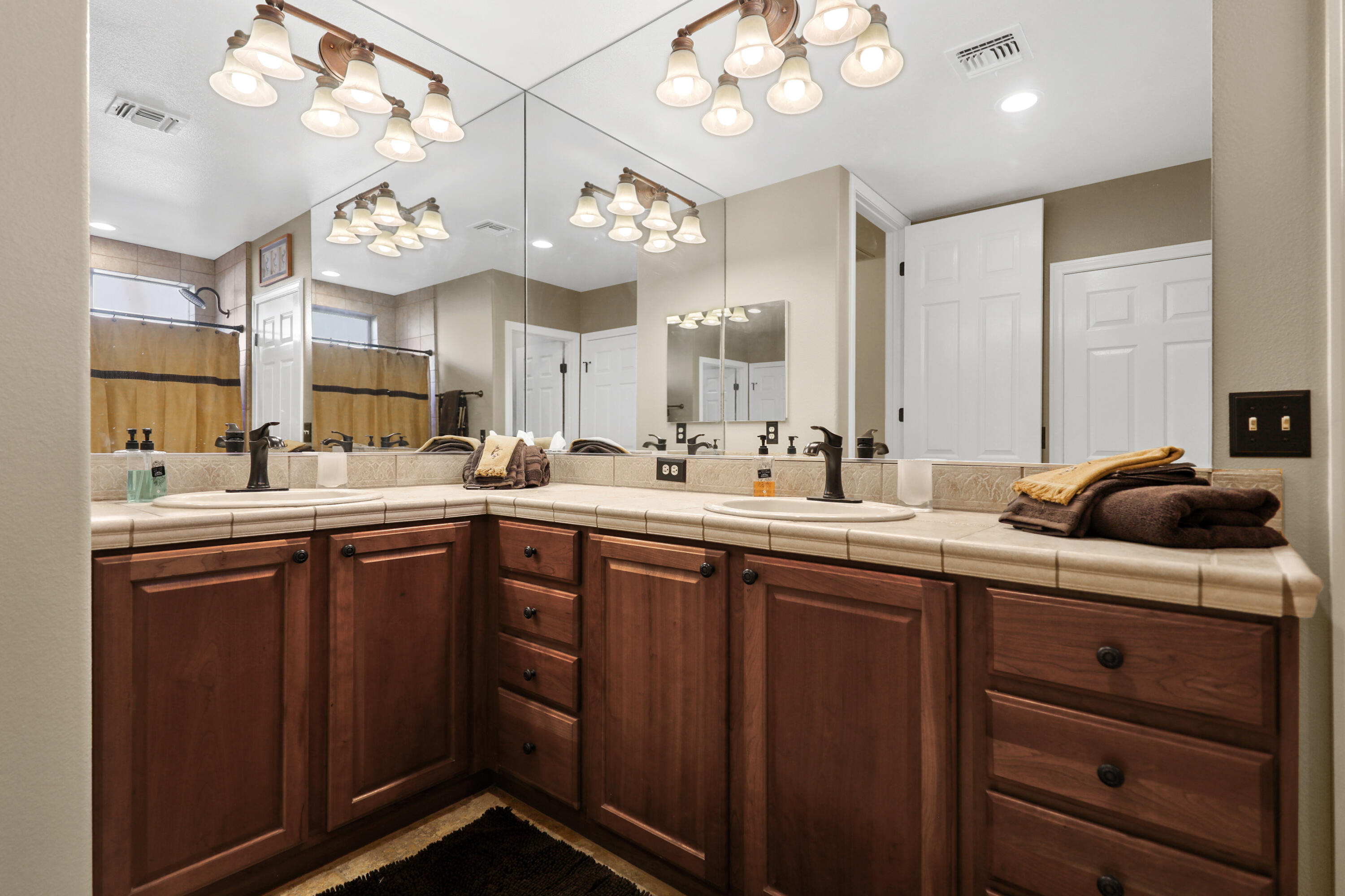 54855 Avenida Madero La Quinta, CA 92253 - Photo 27 of 48 a kitchen with a sink a chandelier and wooden cabinets