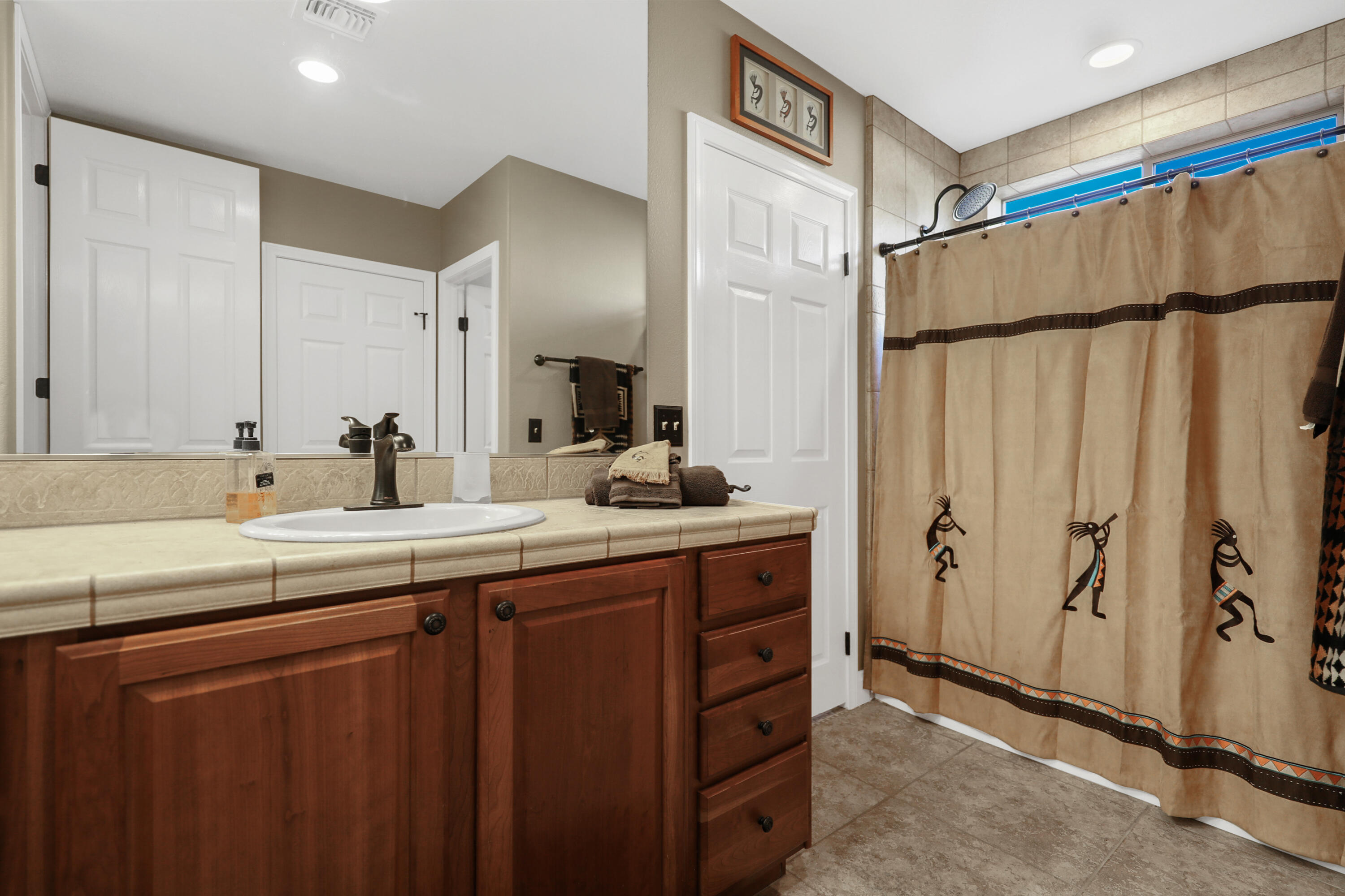 54855 Avenida Madero La Quinta, CA 92253 - Photo 28 of 48 a bathroom with a double vanity sink and mirror