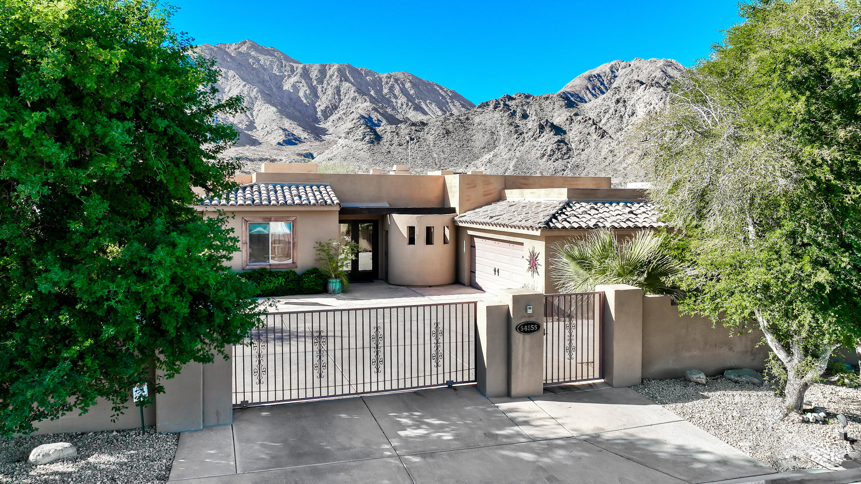 54855 Avenida Madero La Quinta, CA 92253 - Photo 5 of 48 front view of a house with a tree