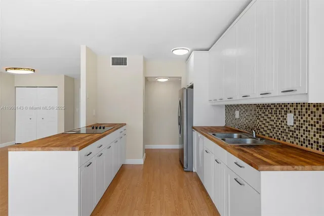 a kitchen with a sink stove and cabinets