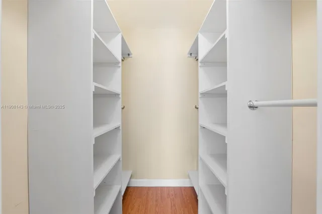 a view of walk in closet with empty racks
