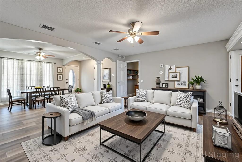 a living room with furniture or couch and a dining table
