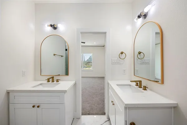 a bathroom with a double vanity sink mirror and