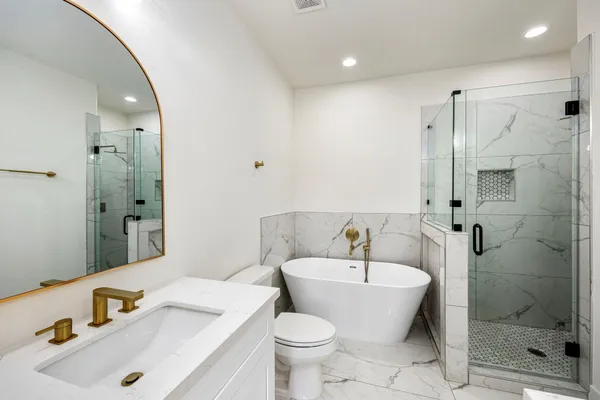 a bathroom with a sink toilet and shower