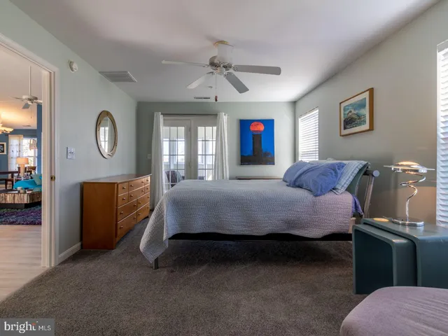 a bedroom with a bed dresser and a window