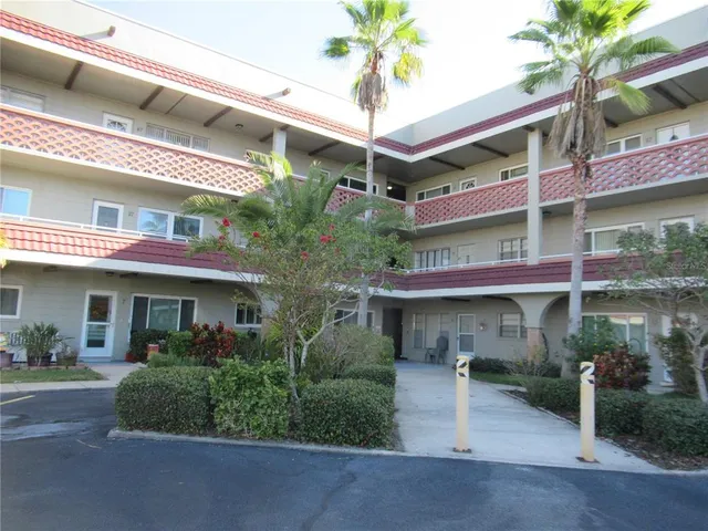 a front view of a building with garden