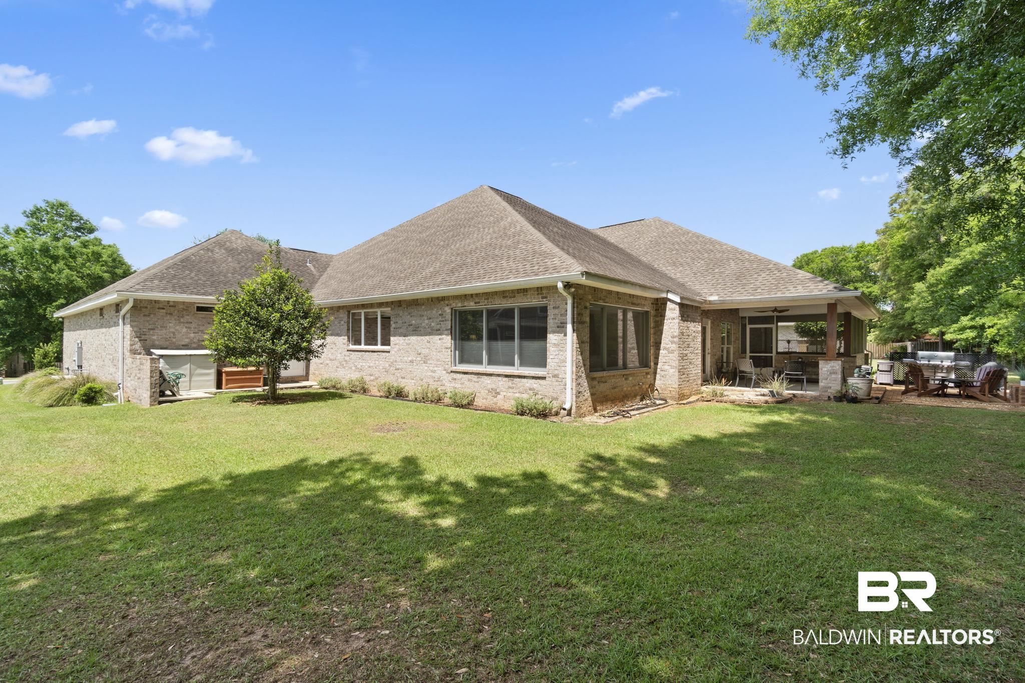 8664 Foxtail Loop Pensacola, FL 32526 - Photo 54 of 64 Rear view of property featuring a patio area, brick siding, ceiling fan, a yard, and roof with shingles