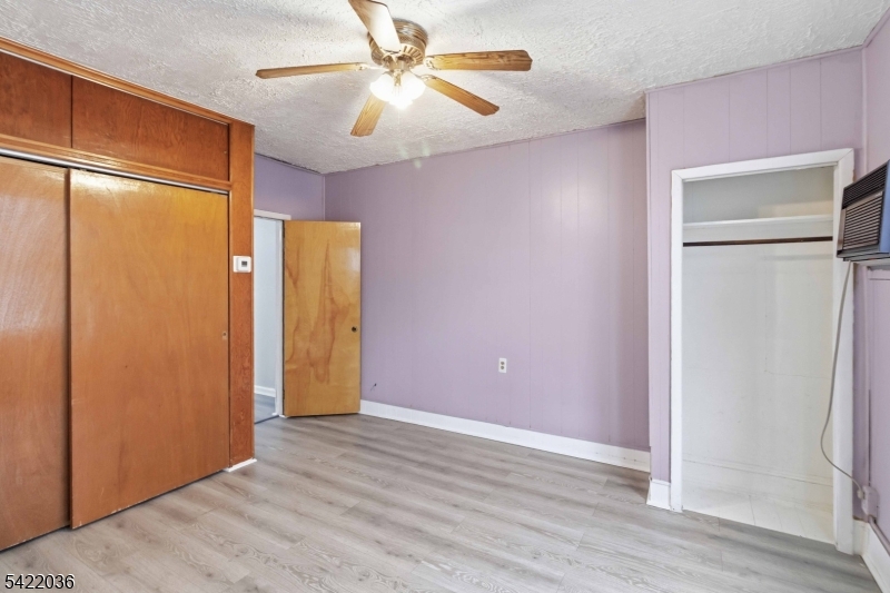 36 Edison Street Bloomfield, NJ 07003 - Photo 9 of 28 an empty room with wooden floor and a ceiling fan