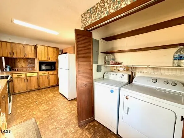 a large kitchen with kitchen island granite countertop a sink and counter top space
