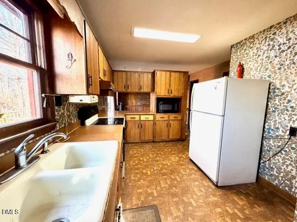 a kitchen with stainless steel appliances a stove a sink and a microwave