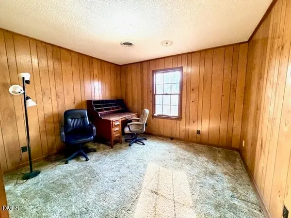 a view of a hallway with wooden walls and stairs