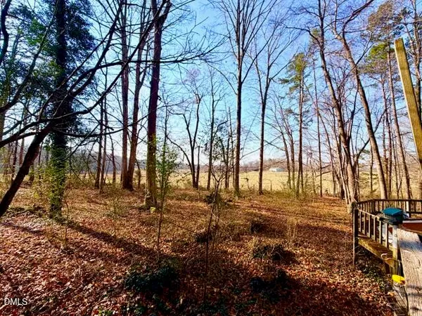 a view of backyard with wooden fence