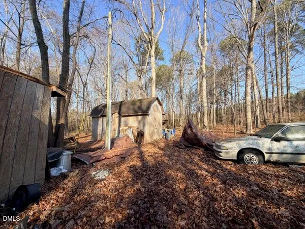 a view of a house with a yard covered with snow
