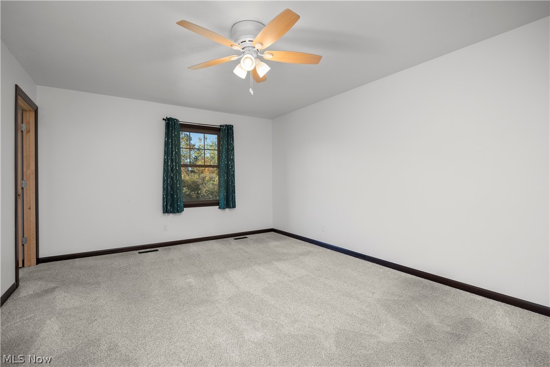 6760 Mason Road Berlin Heights, OH 44814 - Photo 14 of 49 Carpeted empty room with baseboards and ceiling fan