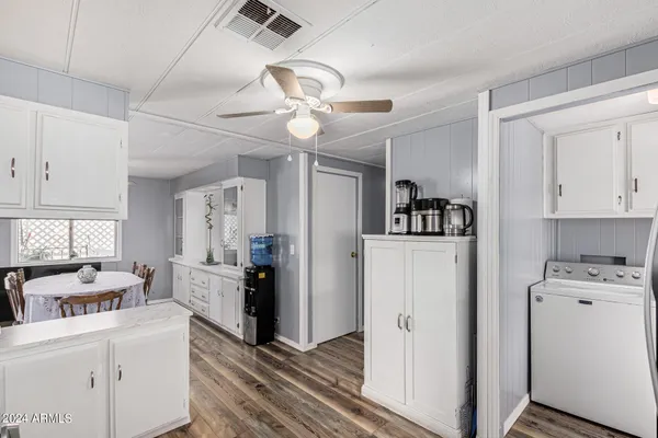 a kitchen with a sink stainless steel appliances and white cabinets