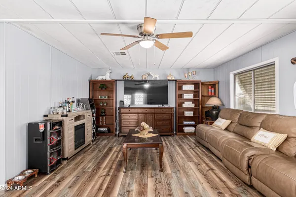 a living room with furniture ceiling fan and a window