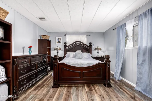 a bedroom with a bed and a dresser