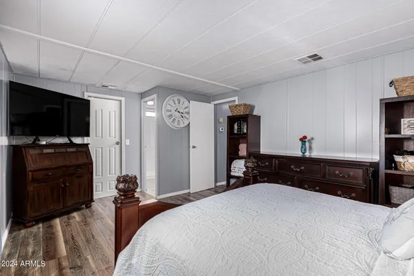 a bedroom with a bed and a television