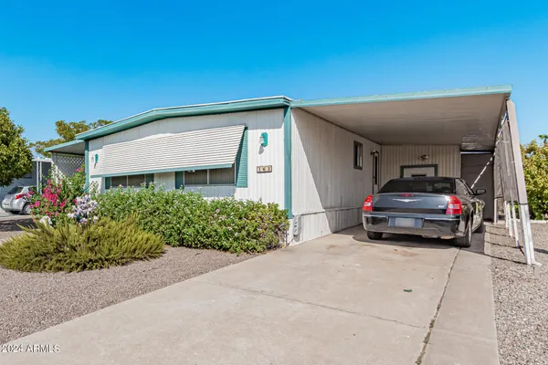 a car parked in front of yellow house