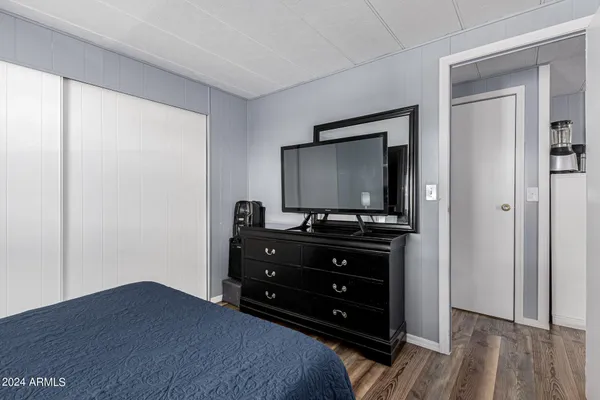 a bedroom with a bed and a flat tv screen