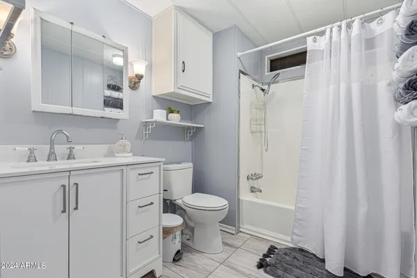 a white toilet sitting next to a bathroom sink