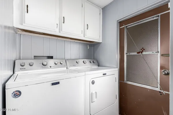 a open kitchen with stainless steel appliances granite countertop a refrigerator a stove and a sink with cabinets