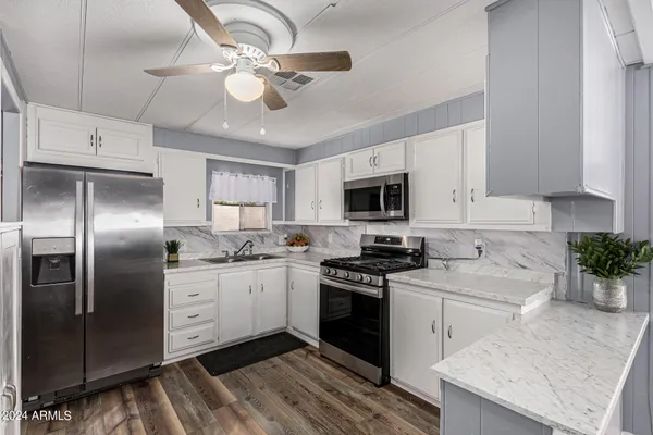 a kitchen with a refrigerator sink and cabinets