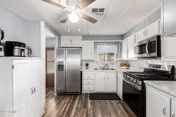 a view of walk in closet with clothes