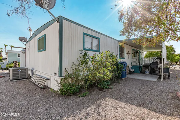 a kitchen with a dining table chairs and refrigerator