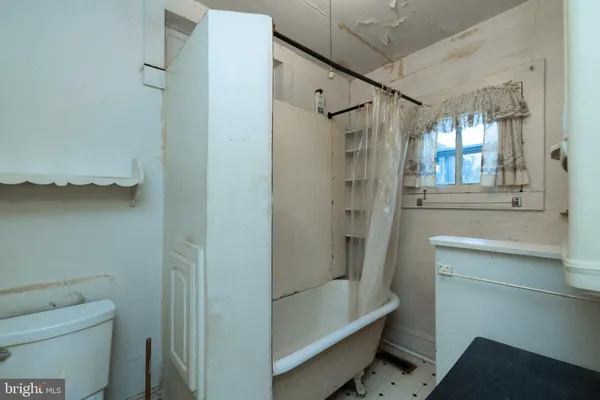 a bathroom with a shower a toilet and a sink