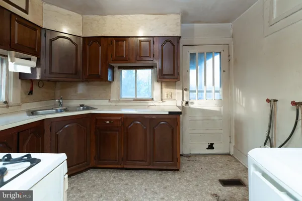 a kitchen with a sink and a stove top oven