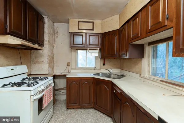 a kitchen with stainless steel appliances granite countertop a sink stove and cabinets