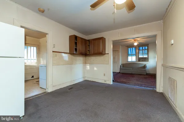 a view of a big room with closet and chandelier fan