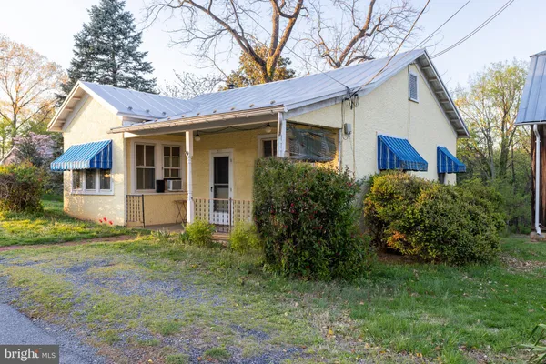 a front view of a house with table and chairs