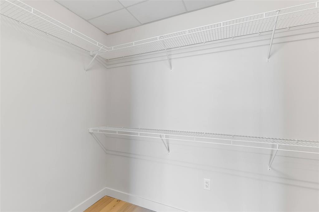 44 East Avenue, Unit 3109 Austin, TX 78701 - Photo 14 of 37 Spacious closet with a drop ceiling and light wood-style floors