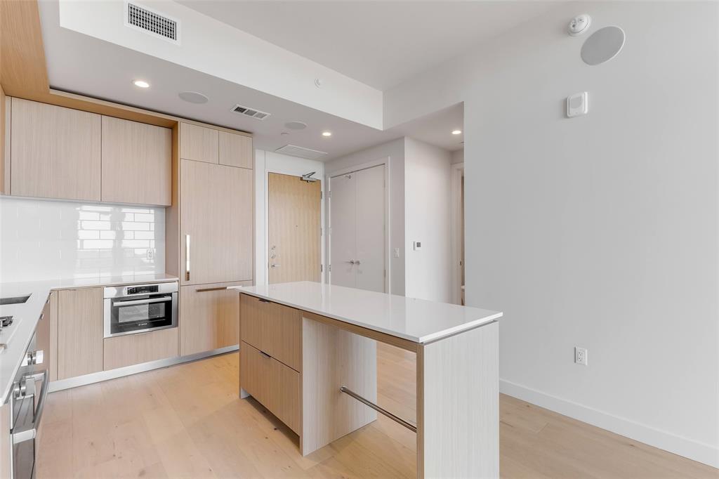 44 East Avenue, Unit 3109 Austin, TX 78701 - Photo 6 of 37 Kitchen featuring stainless steel oven, light wood-type flooring, modern cabinets, and light brown cabinets
